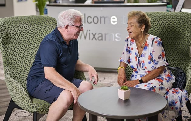 Residents enjoying a conversation in the common area
