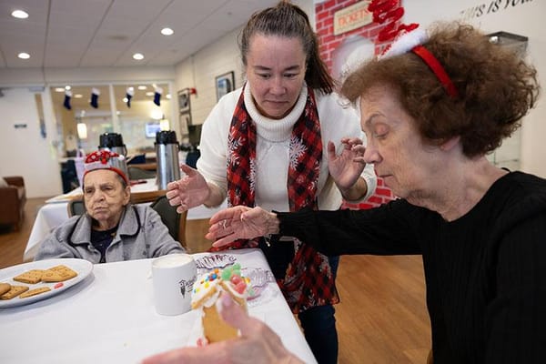 Residents decorating gingerbread cookies during a festive activity