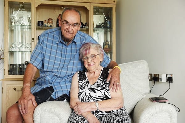 Two residents sitting together in a cozy living room
