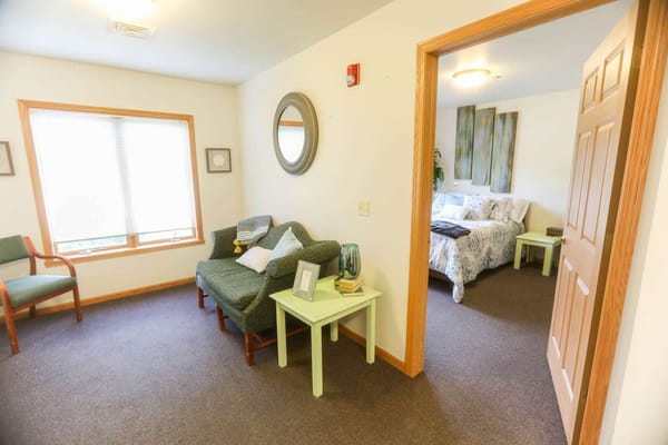 Cozy interior view of a resident room with a sofa and bed