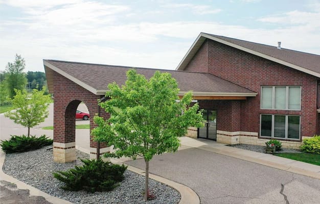 Exterior view of the facility with landscaped entrance.