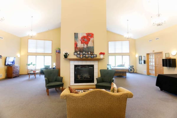 Bright common area with seating and fireplace