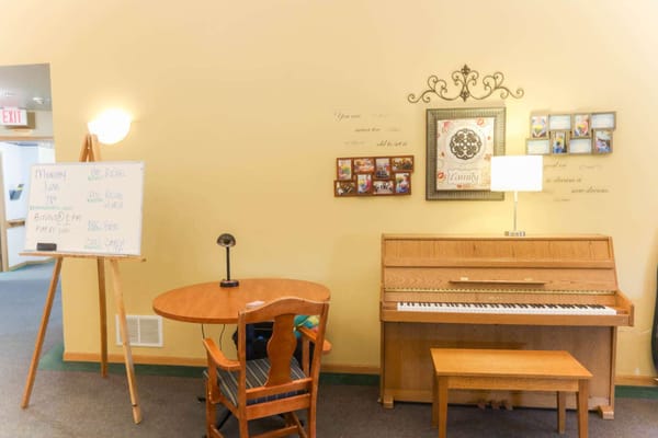Common area with a piano and seating arrangements