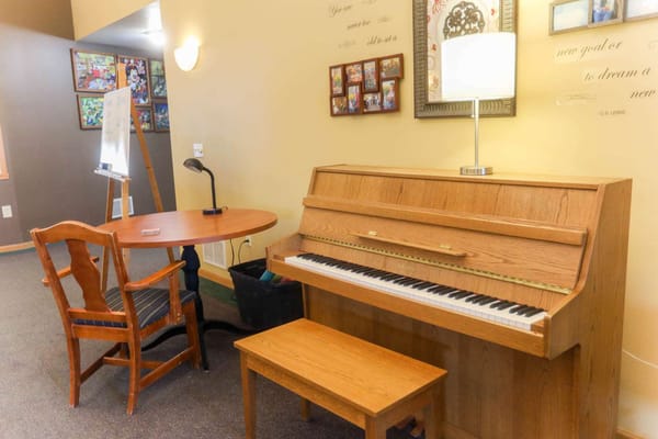 Piano and seating area in a cozy room