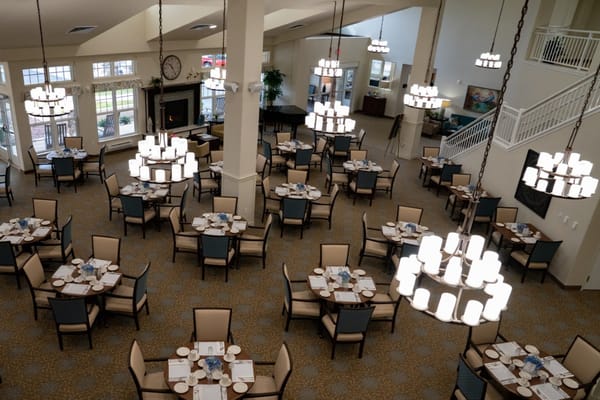 Spacious dining room with tables and chairs set for dining