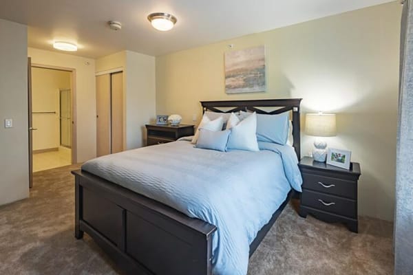 Bright and welcoming resident room with a bed and decor