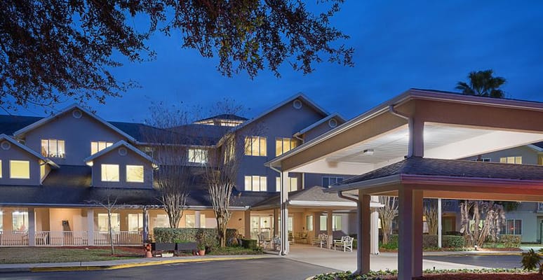 Facade of a senior living facility at dusk