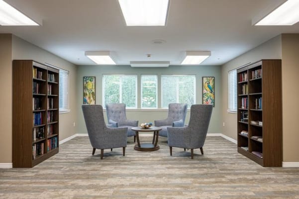 Common area with comfortable seating and bookshelves