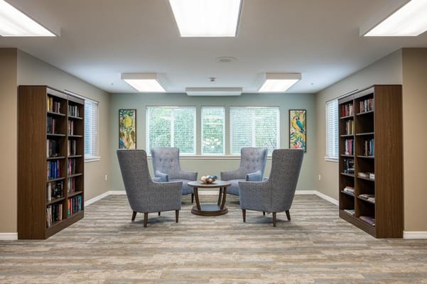 Common area with comfortable seating and bookshelves