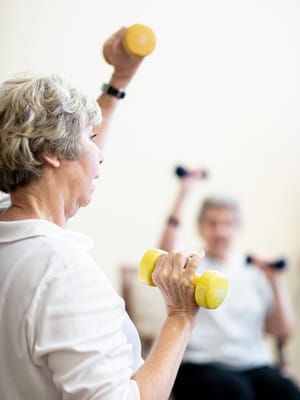Residents engaging in a light exercise session with dumbbells