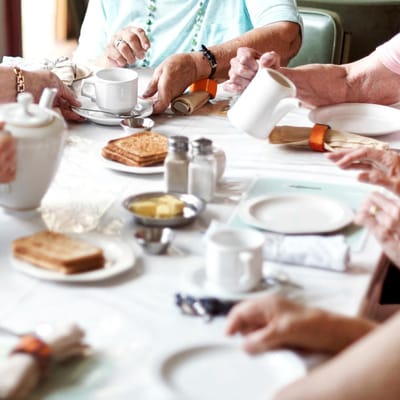 Residents enjoying breakfast at a dining table