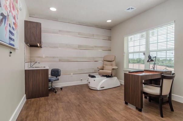 Interior of a therapy room with a recliner and desk