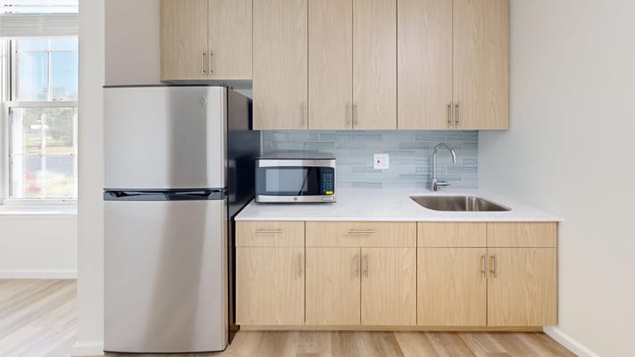 Modern kitchenette in a resident room with appliances