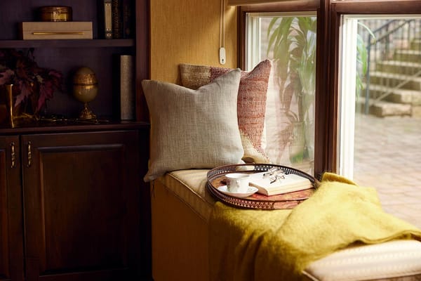 Cozy reading nook with cushions and a tray