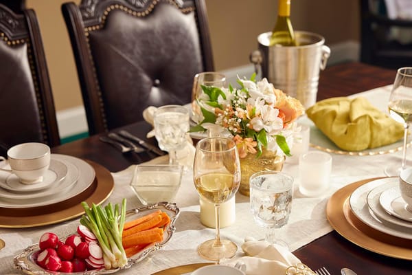 A beautifully set dining table with food and drinks