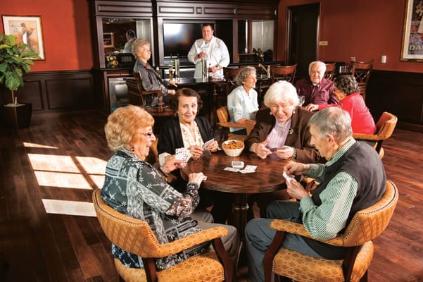 Residents playing cards in a cozy common area