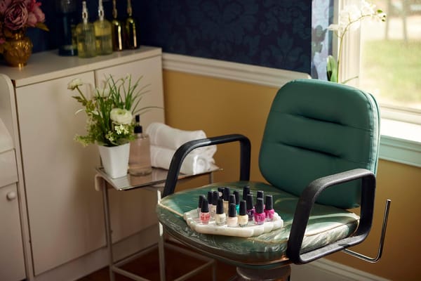 Beauty salon chair with nail polish selections