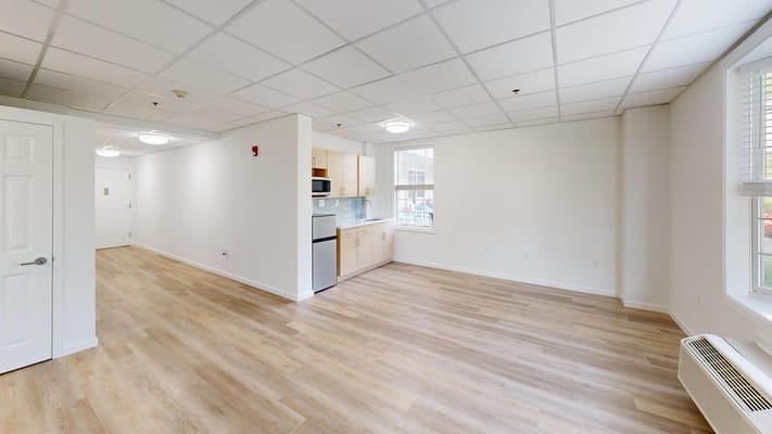 Bright interior of a resident room with kitchenette