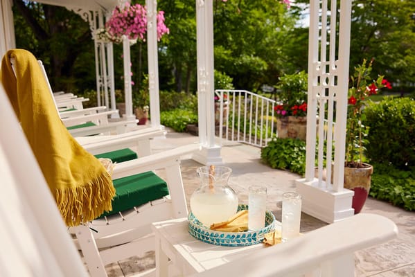 Chairs on a porch with lemonade and a cozy blanket
