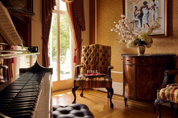 Cozy lounge area with a piano and decorative chair