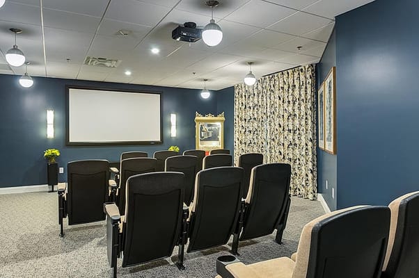 A cozy home theater room with seating and projector