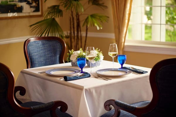 Elegant dining setup with glasses and flower centerpiece