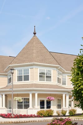 Exterior view of a senior living facility with flowers