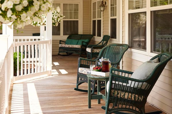 Cozy outdoor seating on a porch with greenery