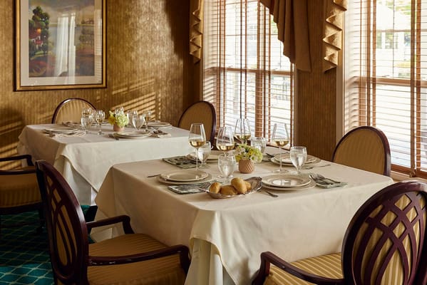 Elegant dining room setup with tables and flowers