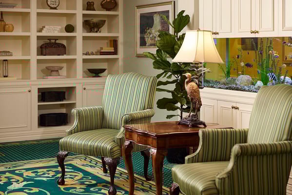 Cozy common area with armchairs and aquarium