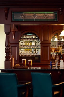 Interior view of a bar area with drinks and decor