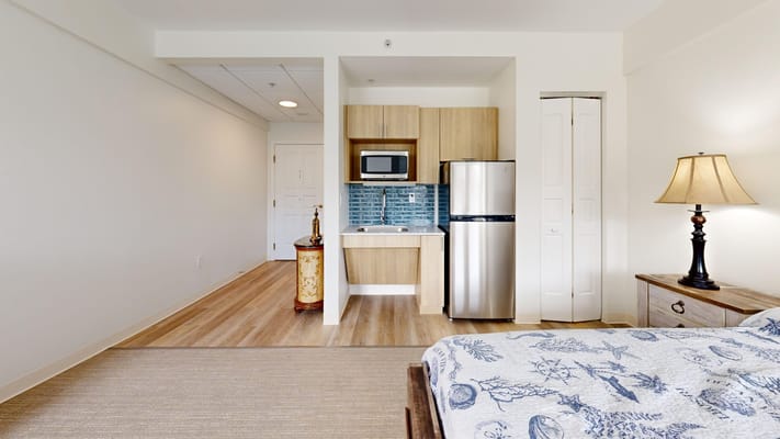 Cozy resident room featuring kitchenette and modern decor