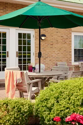 Outdoor seating area with a green umbrella and table