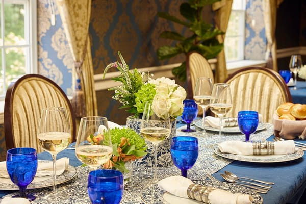 Elegant dining setup with glasses and floral centerpiece