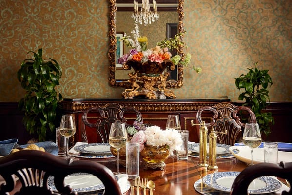 Elegant dining room setup with flowers and fine china