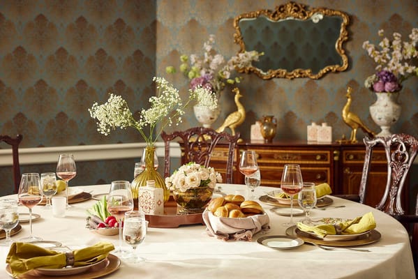 Elegant dining table set with food and flowers