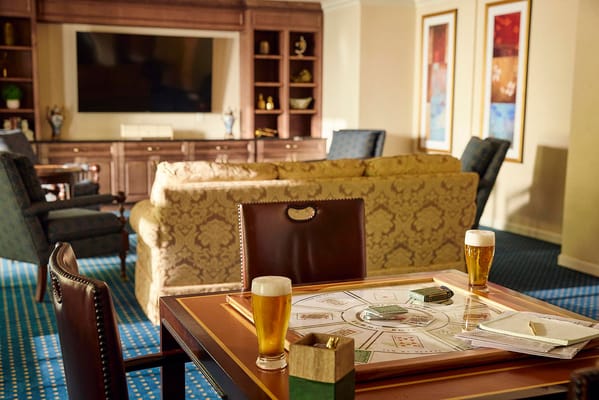 Common area with card game setup and drinks