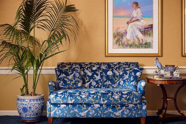 Cozy interior with a floral patterned sofa and artwork