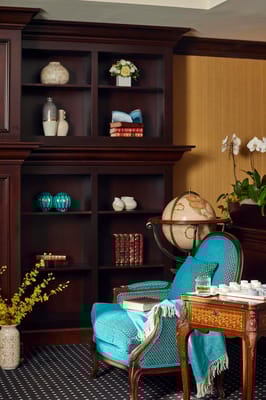 Cozy corner with blue chair and decorative shelves