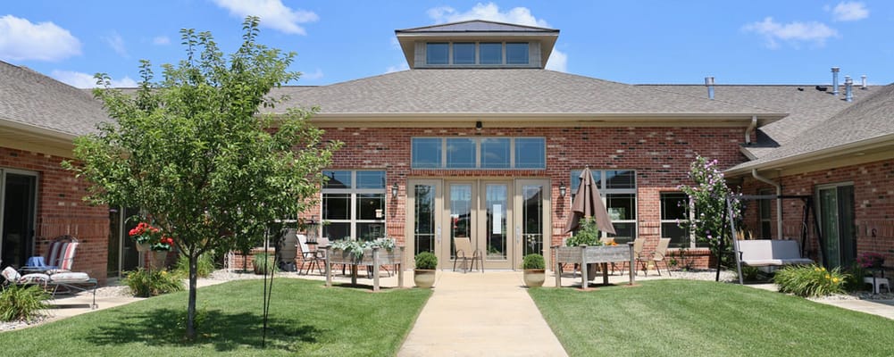 Exterior view of an assisted living facility with gardens