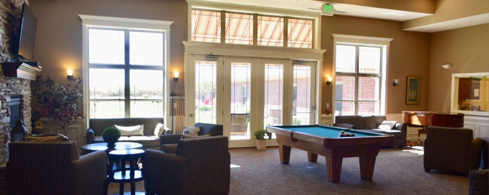 Bright common area with seating and a pool table