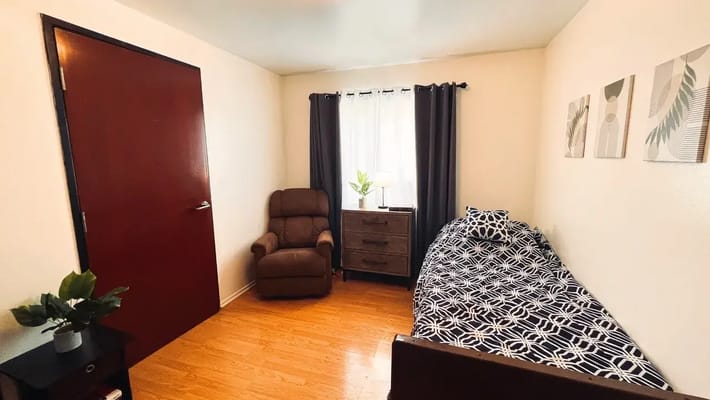Private resident room with a bed and chair