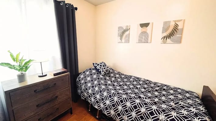 A neatly arranged private resident room with decor