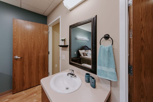 Facility interior with a bathroom and bedroom view