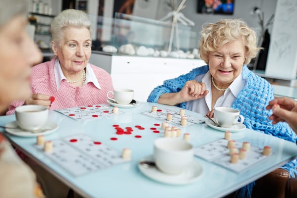 Residents playing bingo with cups of coffee