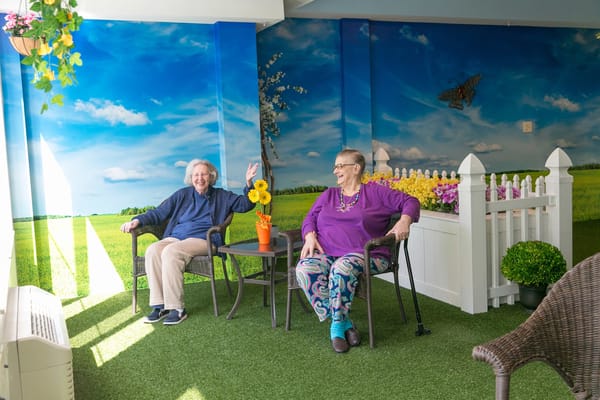 Two residents enjoying a bright indoor space