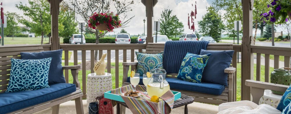 Cozy outdoor seating area with drinks and cushions
