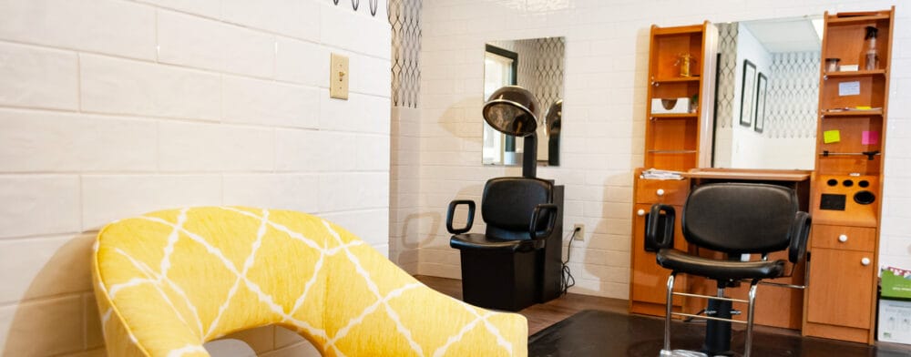 Interior view of a hair salon with chairs and decor