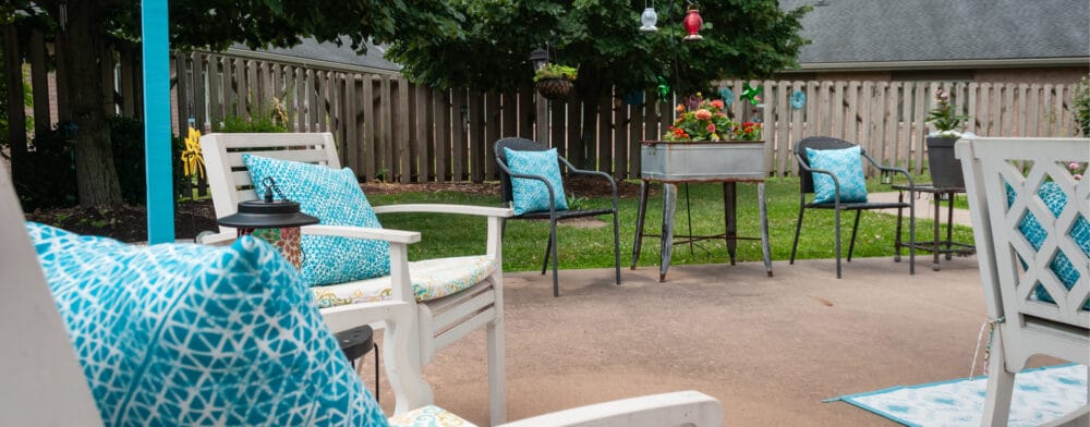 Outdoor seating area with vibrant cushions and flowers
