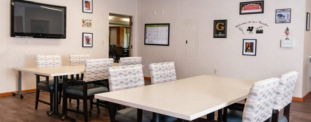 Activity room with tables and chairs in a well-lit space